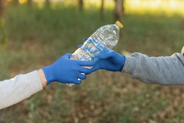 Close up hands holding plastic bottle