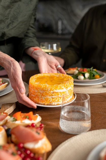 Close up hands holding plate with cake