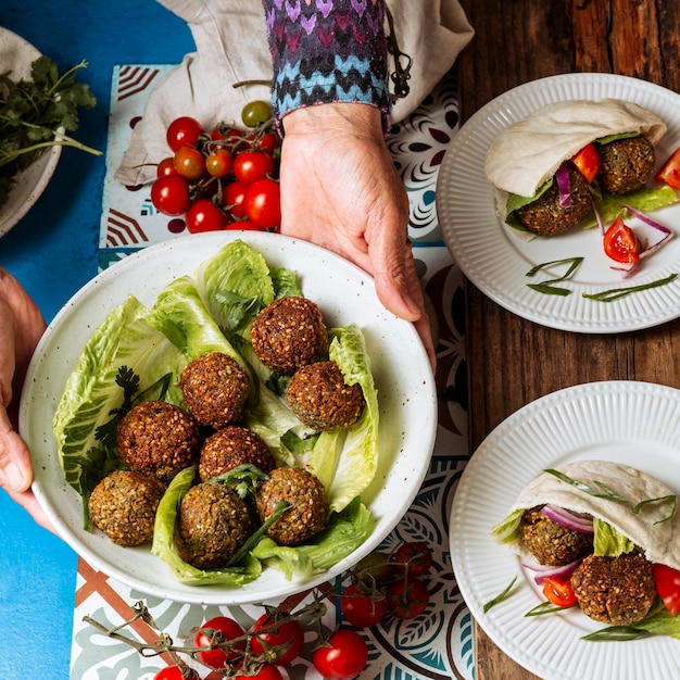 Close-up hands holding plate with jewish food