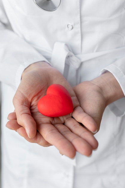 Free photo close up hands holding red heart