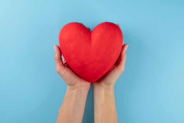 Close up hands holding red heart