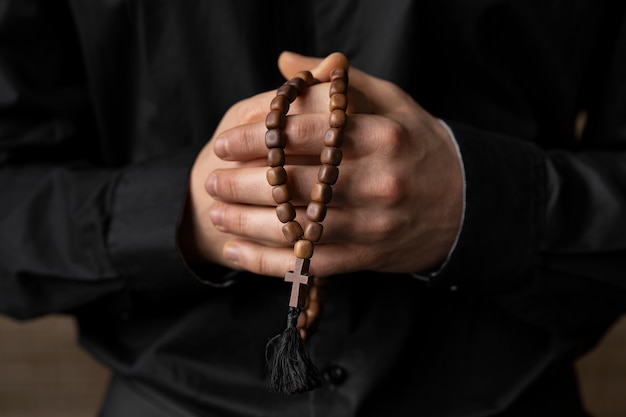 Free photo close up hands holding rosary