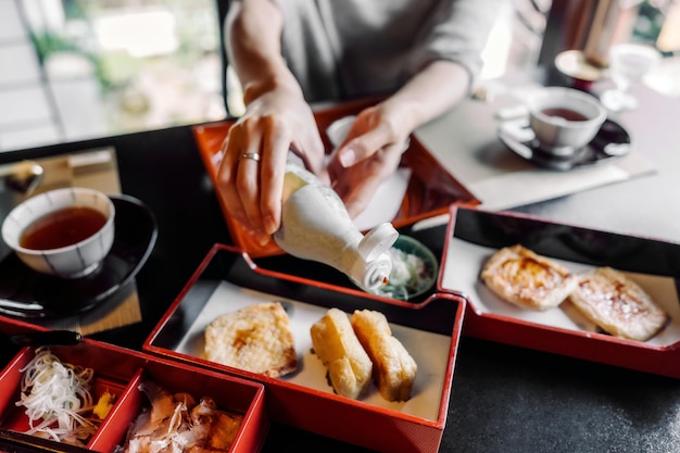 Free photo close up hands holding sauce bottle