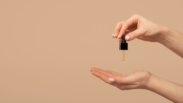 Close up hands holding serum