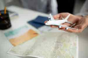 Free photo close up hands holding small plane