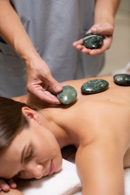 Close up hands holding spa stones