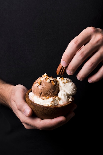 Free photo close-up hands holding tasty gelato scoops