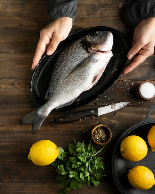 Close-up hands holding tray with fish