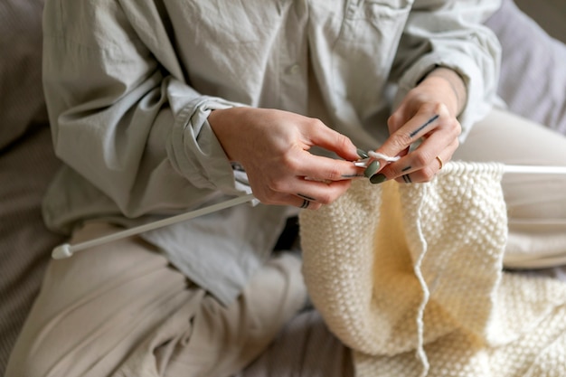 Close up hands knitting with knitters