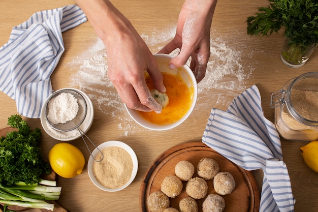 Close up hands making food croquettes