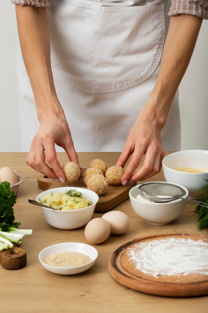 Close up hands making food croquettes