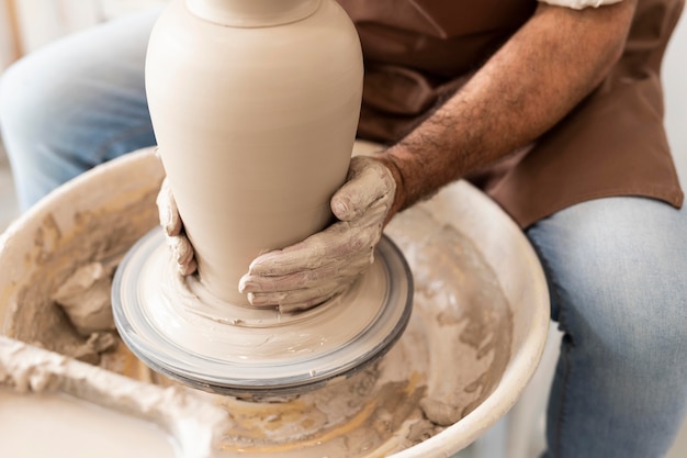 Free photo close up hands making pot