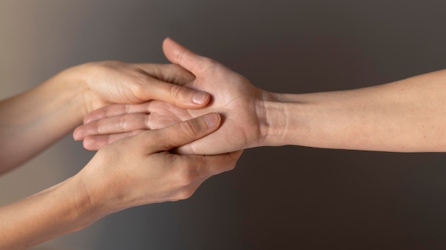 Free photo close-up hands massaging palm