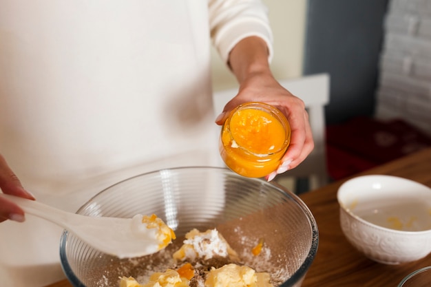 Free Photo close-up of hands mixing ingredients in bowl