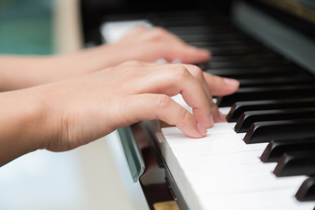 Close-up of hands playing piano