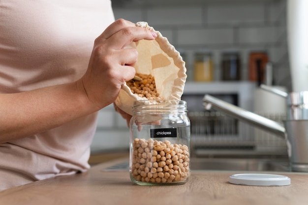 Close up  hands pouring chickpeas from bag