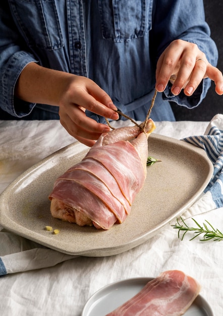 Close-up hands preparing chicken