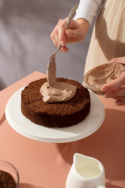 Close up hands preparing delicious cake