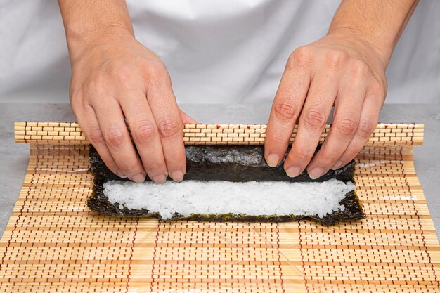 Close-up hands preparing delicious sushi