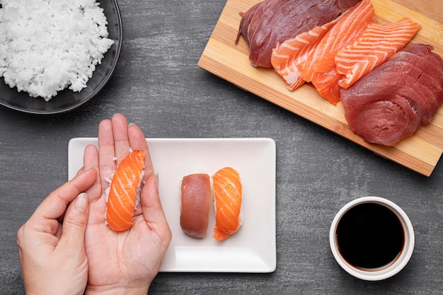 Free Photo close-up hands preparing sushi