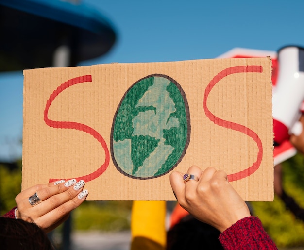 Free Photo close up hands protesting with placard