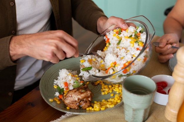 Free photo close up hands putting food on plate