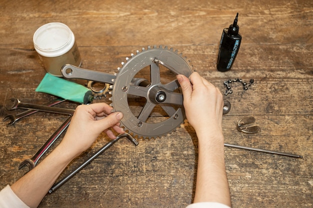 Free Photo close up hands repairing bike parts