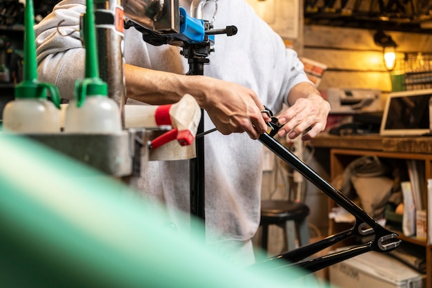 Free photo close up hands repairing bike