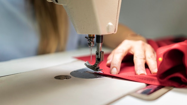 Close-up hands sewing with machine