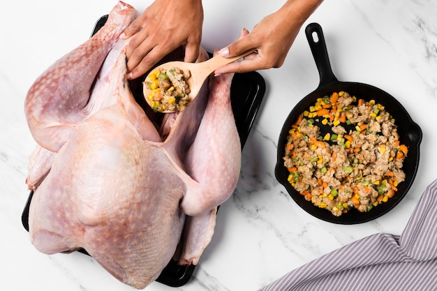 Close-up hands stuffing turkey