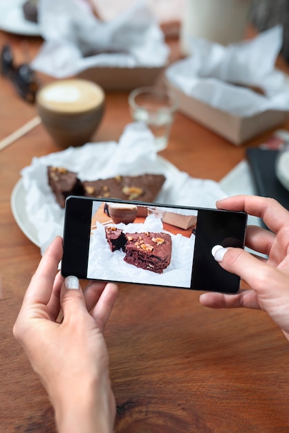 Free photo close up hands taking cake photos