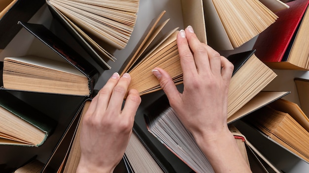 Close up hands touching books