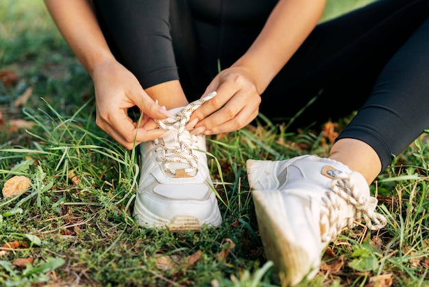 Free Photo close-up hands tying shoelaces