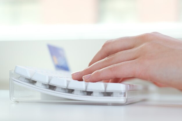 Close up of hands typing on keyboard in the workplace