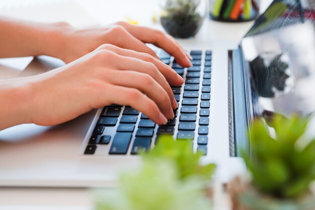 Close up hands typing on keyboard