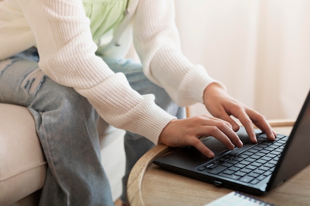 Free photo close up hands typing on laptop