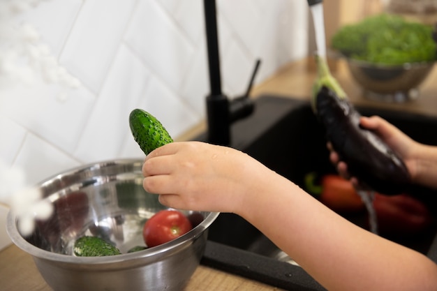 Free Photo close up hands washing vegetables