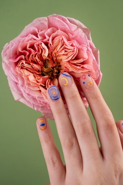 Close up hands with beautiful manicure and flower