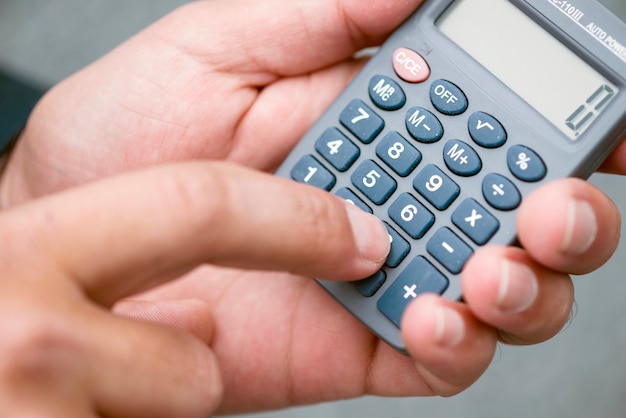 Free Photo close-up of hands with calculator