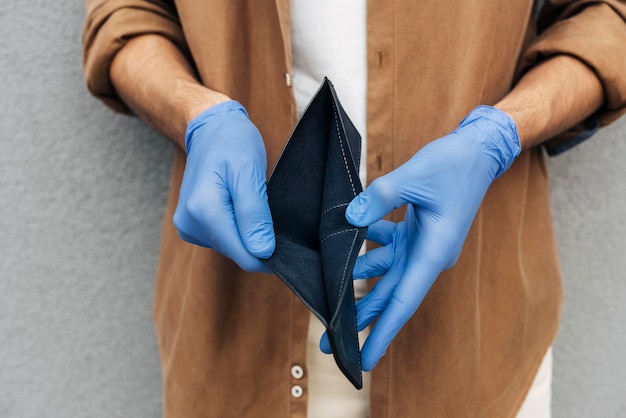 Free photo close-up hands with gloves holding wallet