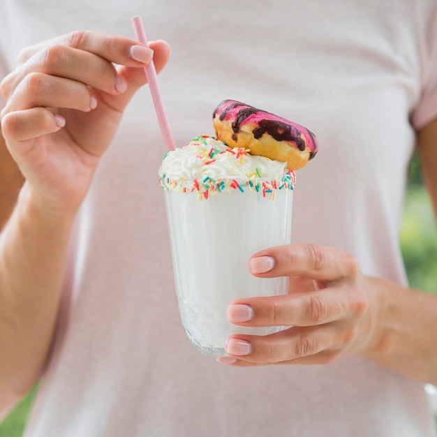 Close-up hands with shake and straw