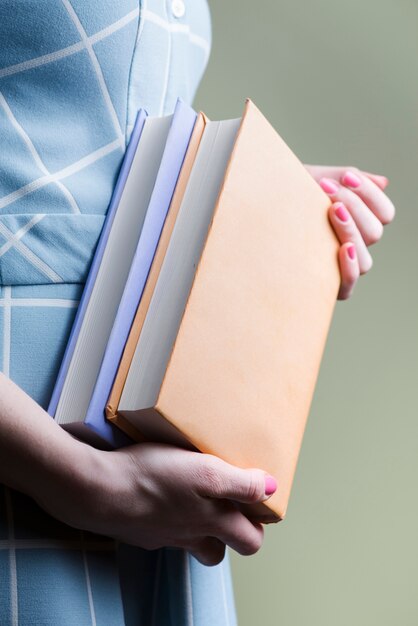 Close-up of hands with two thick books