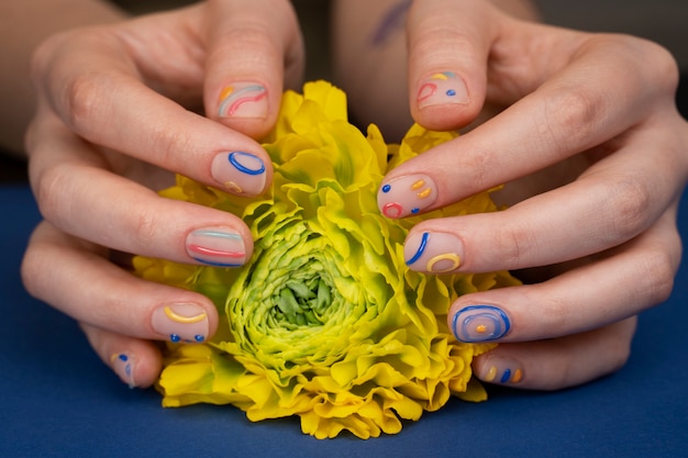 Free photo close up hands with yellow flower