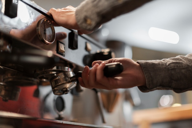 Free photo close-up of hands working on coffee machine