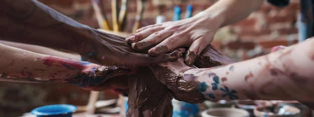 Free photo close up on hands working on pottery