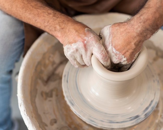 Free Photo close up hands working with clay