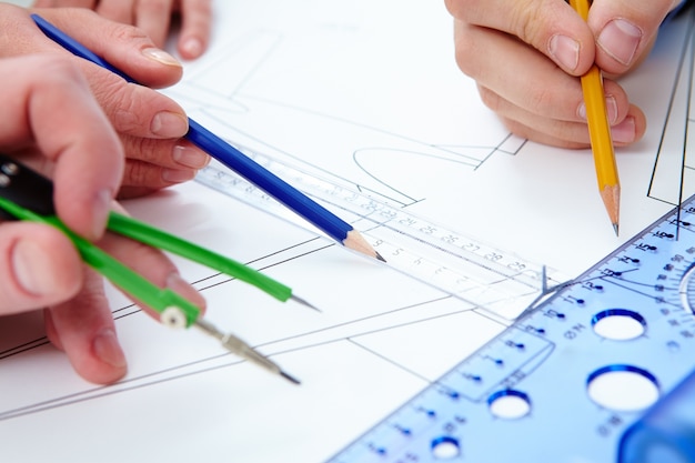 Free Photo close-up of hands working with pencils and rulers