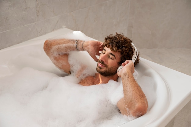 Close up on handsom man taking a bath