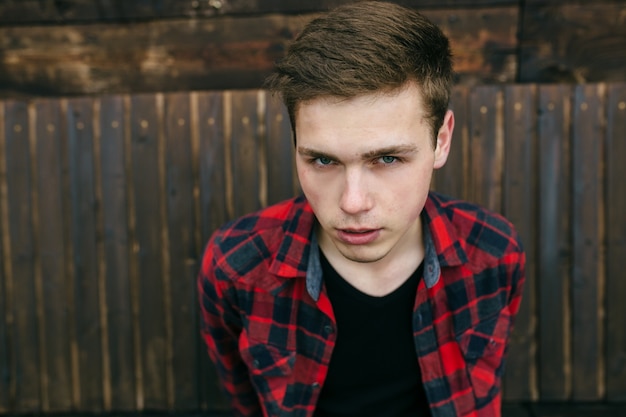 Close-up of handsome teenager wearing a plaid shirt