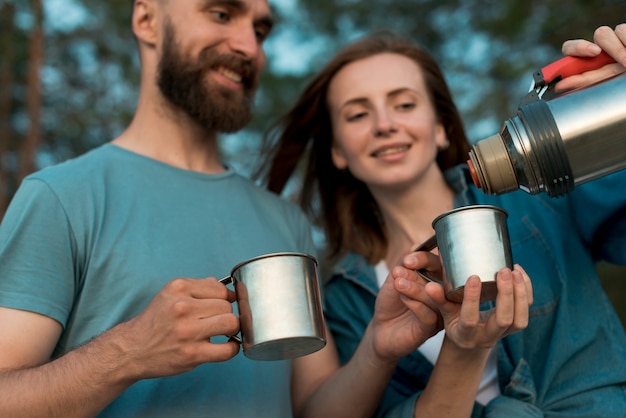 Free photo close up of happy couple pouring tea